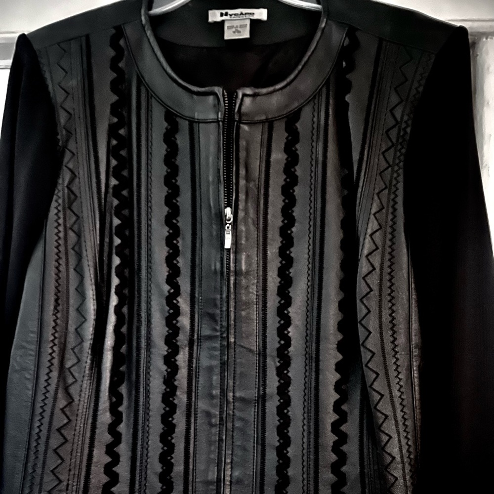 Black leather jacket with a knit sleeve and back.